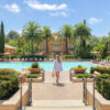 Woman standing in front of apartment pool