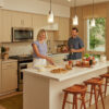 Couple in apartment home making pizza and preparing wine